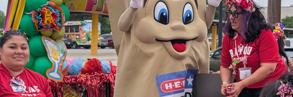 HEB Buddy and volunteers on parade float.