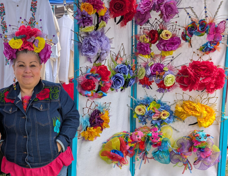 Vendor selling festive wreaths and flower crowns.